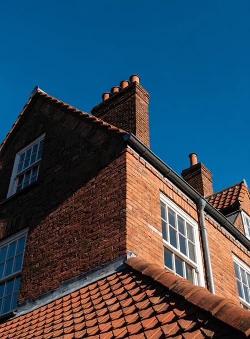 House roofline against blue sky